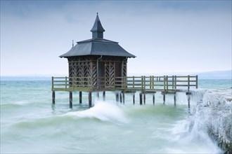 Iced bathhouse in stormy wind