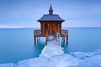 Iced bathhouse at dawn