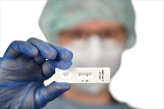 Medical staff shows negative antigen rapid test