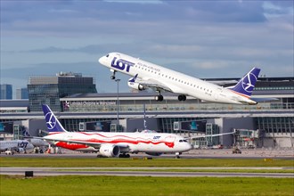 An Embraer 195 of LOT Polskie Linie Lotnicze with the registration SP-LNE takes off from Warsaw Airport