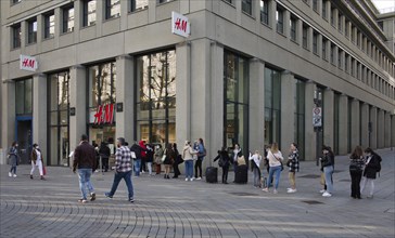 Customers queue up in front of H&M