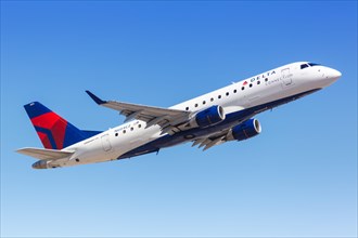 A Delta Connection Embraer ERJ 175 aircraft with registration N604CZ takes off from Phoenix Airport