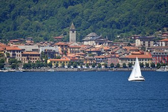 Sailboat in front of the old town of Cannobio