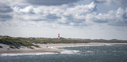 Sea and red-white lighthouse List-East in the dunes