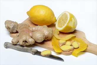 Ginger root and lemon on wooden board