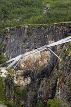 Metal bridge over a rock gorge at Voringfossen waterfall