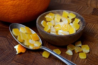 Candied orange peel cubes in small bowls and spoon