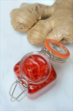 Pickled ginger in glass and ginger root