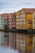 Colourful historic warehouses by the river Nidelva