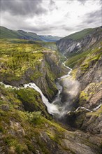 View into the river valley with waterfall Voringfossen