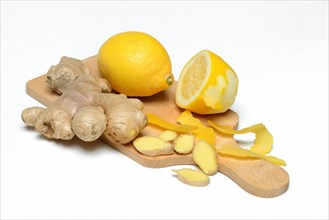 Ginger root and lemon on wooden board