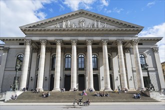 People sunbathing in front of the opera