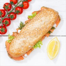 Sandwich baguette wholemeal bun topped with salmon fish square from top to bottom