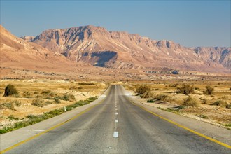 Endless road driving empty desert landscape boundless lonely infinite distance in Israel