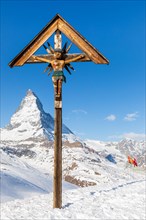 Jesus on wooden cross near Matterhorn