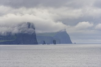 Risin and Kellingin rock needles next to 350m high cliffs