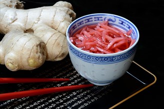 Pickled ginger in small bowls and ginger root