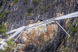 Metal bridge over a rock gorge at Voringfossen waterfall
