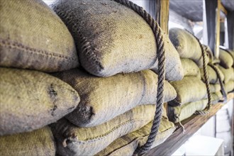 Coffee beans packed in sackcloth bags mounted with rope for transportation