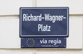 Street sign Richard-Wagner-Platz and sign for the Via Regia European Cultural Route on a house wall