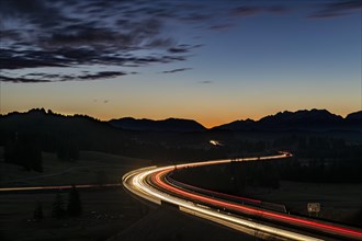 Motorway at blue hour with traces of cars in Allgaeu landscape