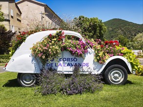 White Citroen 2CV with the inscription Corso de la Lavande