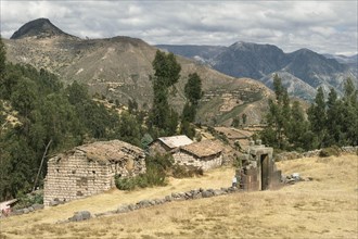 Inca sun gate in front of crumbling house