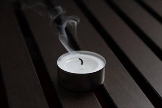 Tea light on wooden background