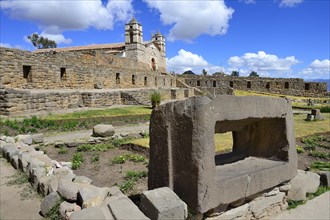 Sacrificial stone in front of the Inca Sun Temple with attached cathedral from the colonial period