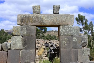 Dilapidated house behind a gate to the pyramid of the Incas