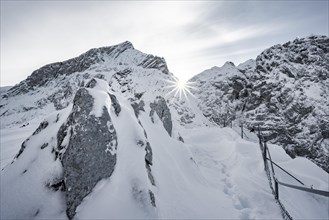Snowy Alpspitze with sun star