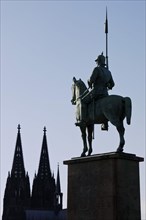 Monument of the 8th Prussian Cuirassier Regiment with the silhouette of the cathedral