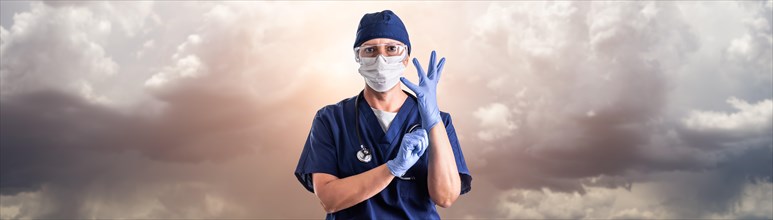 Doctor or nurse adjusting surgical gloves wearing personal protective equipment over ominous clouds