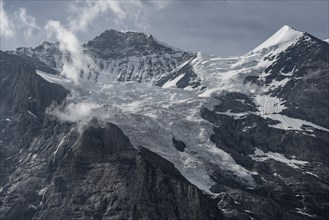 Snow covered mountain peaks Jungfrau and Silberhorn with glacier Jungfraufirn
