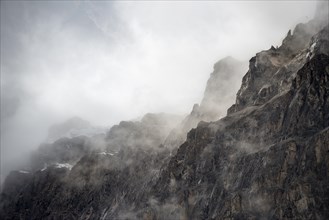 Snowy mountain top covered with clouds
