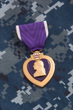 United states purple heart war medal on navy camouflage material