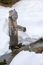 Wooden fountain in winter