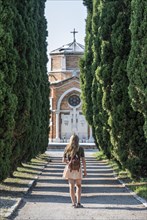Young woman on the main path of the cemetery island San Michele