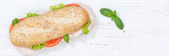 Sandwich baguette wholemeal roll topped with ham banner text free space copyspace copyspace from above