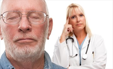 Concerned senior man and female doctor behind with selective focus the gentleman in front