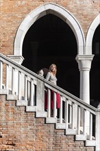 Young woman walking down a staircase