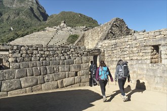 Hiker with backpack in the ruined city of the Incas