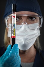 Female Lab Worker Holds Test Tube of Blood Labeled Coronavirus COVID-19 Disease