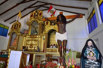 Indigenous Jesus on the cross in the village church Iglesia Virgen Del Carmen