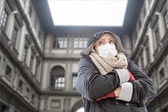 Young Woman Wearing Face Mask Walks Near the Uffizi Gallery