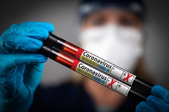 Female Lab Worker Holds Test Tubes of Blood Labeled Coronavirus COVID-19 Disease