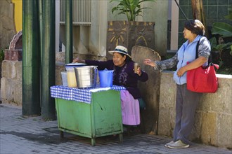 Old woman selling juices at the train station