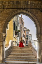 Young woman with red skirt on stairs