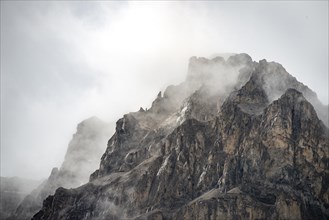 Snowy mountain top covered with clouds