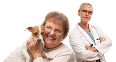 Happy senior woman with her dog and veterinarian isolated on a white background